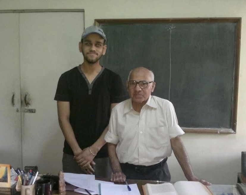 Prof. Gupta in his office with Digvijay Singh Bhadouria, blackboard behind them.